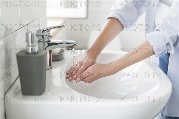 Side view woman using water wash her hands