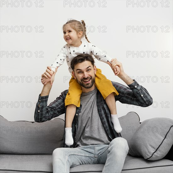 Medium shot father holding girl shoulders