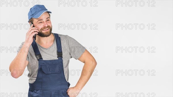 Man overall talking by phone