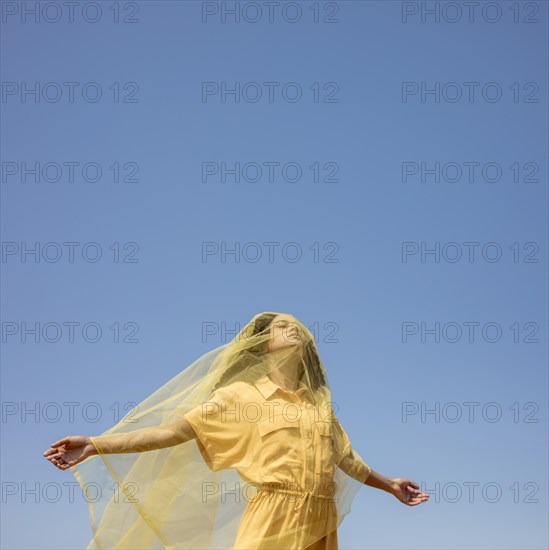 Portrait joyful woman with yellow cloth nature