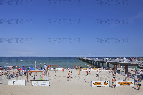 Tourists playing beach volleyball and soccer at Timmendorfer Strand