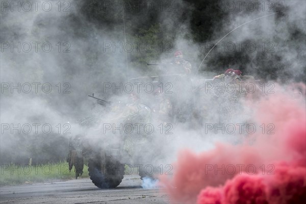 Smoke curtain and Belgian paracommandos of the Para-Commando Regiment under attack in camouflaged LRPV armoured vehicle