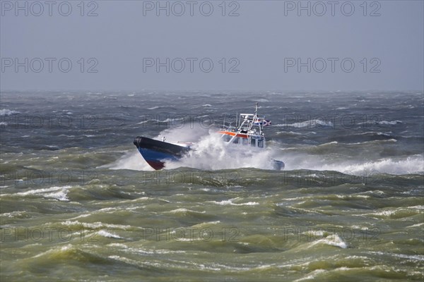 Rescue lifeboat KNRM Jan van Engelenburg from Hansweert patrolling in stormy weather in winter along the North Sea coast of Zeeland