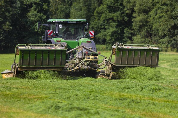 Grass mowing in a small field near Waldheim with a John Deere tractor