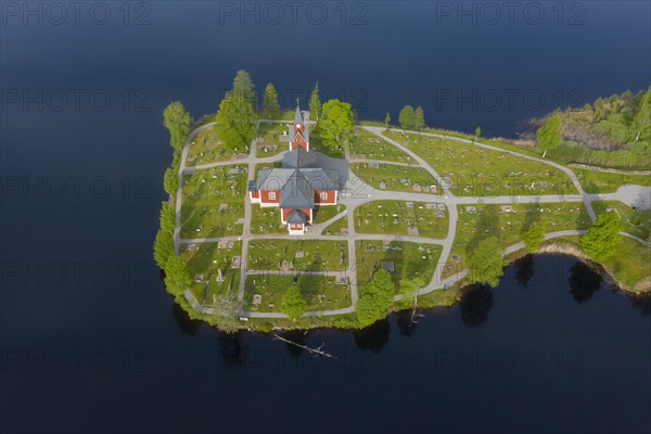 Aerial view over the red wooden Raemmens kyrka