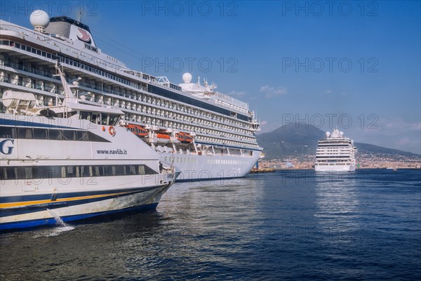 Cruise ships at Statione Marittima in port with Mount Vesuvius
