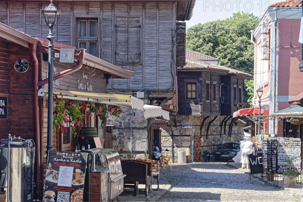 Half-timbered houses with wooden tops and roof overhangs typical of the locality on the cobbled street in the old town. Sozopol