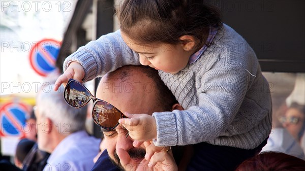 Daughter on father's shoulder