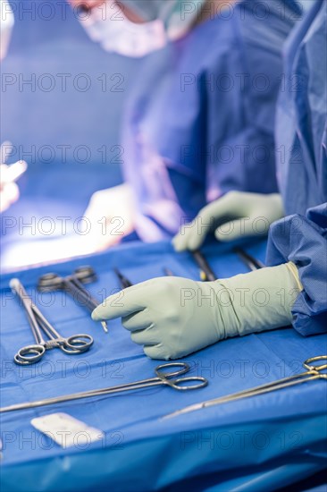 Operating table with surgical cutlery during an operation in a hospital