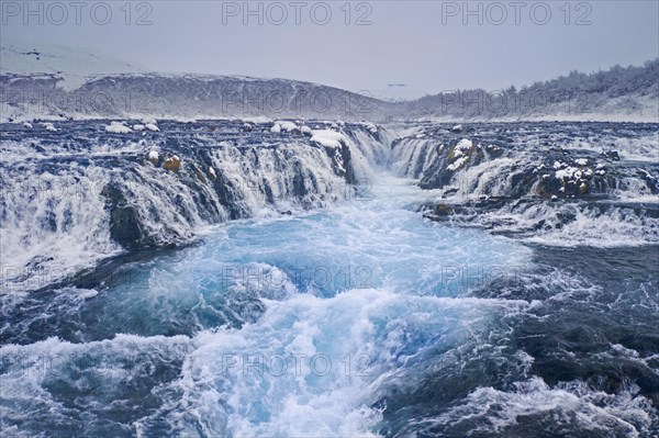 Aerial view over Bruarfoss waterfall in winter