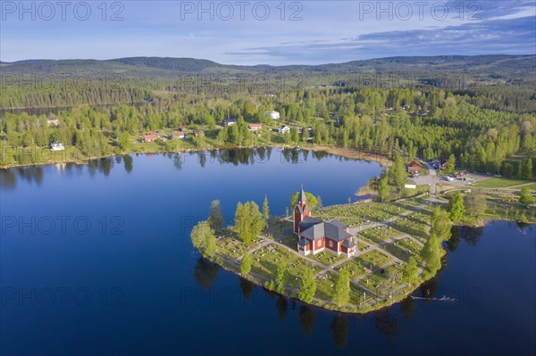 Aerial view over the red wooden Raemmens kyrka