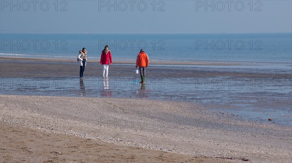 Beach walkers in winter at Lido di Venezia