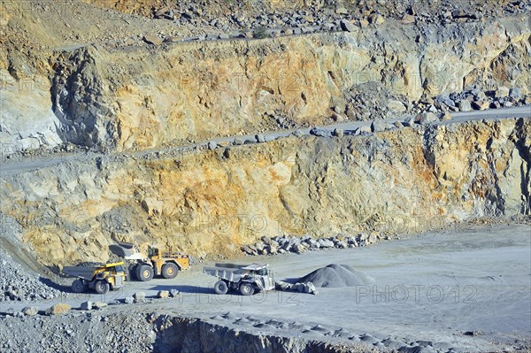 Trucks at work in porphyry quarry