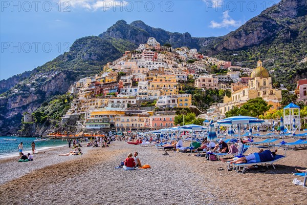 Beach with beach chairs and view of the village