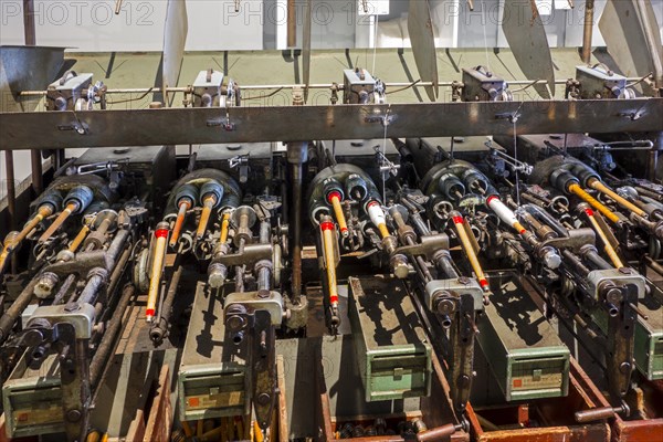 Bobbins with yarns on spool machine in cotton mill