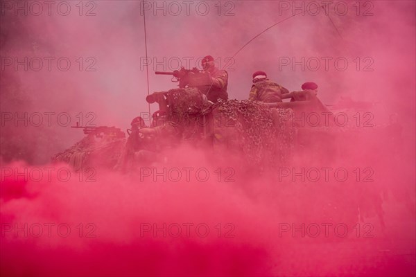 Red smoke curtain and commandos of the Para-Commando Regiment under attack in LRPV armoured vehicle firing mounted machine guns