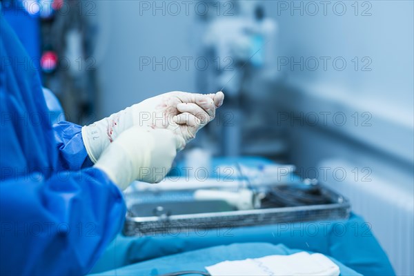 A doctor holds suture wire during an operation at the hospital