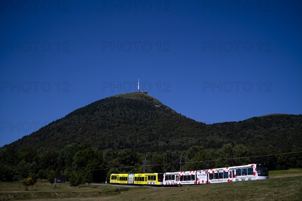 Panoramique des Domes cogwheel railway in Tour de France 2023 all-car advertising ascends Puy de Dome