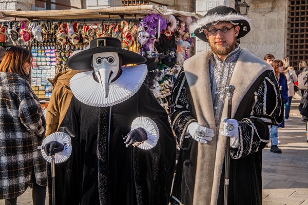 Carnival Mask Plague Doctor and Man in Renaissance Garb at the Time of Carnival