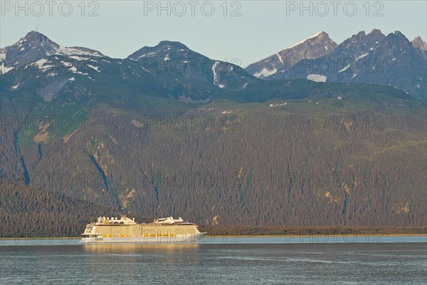 Cruise ship in front of high mountains