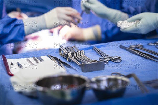 Operating table with surgical cutlery during an operation in a hospital