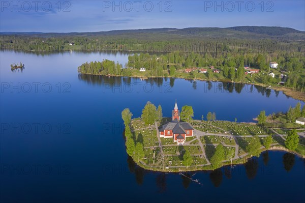 Aerial view over the red wooden Raemmens kyrka