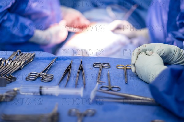 Operating table with surgical cutlery during an operation in a hospital