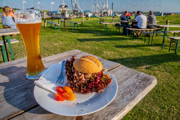 Typical crab roll with a beer in the beer garden of the Siebhaus am Kutterhafen
