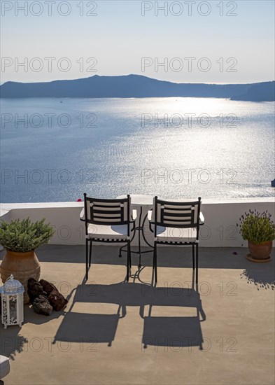 Sea and caldera view from terrace with chairs