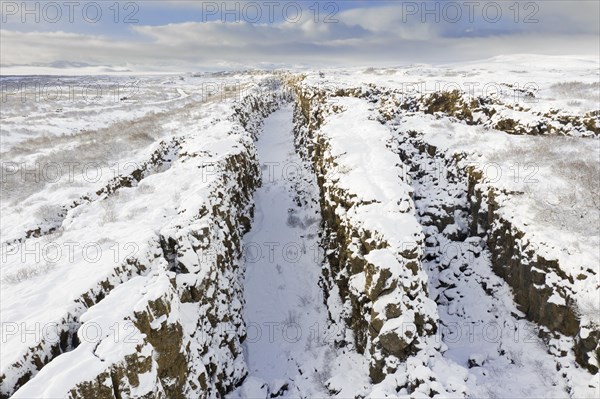 Aerial view over the Almannagja Canyon in the snow in winter