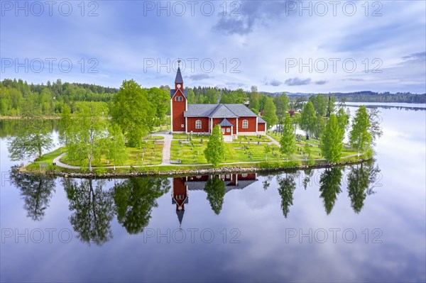 Aerial view over the red wooden Raemmens kyrka