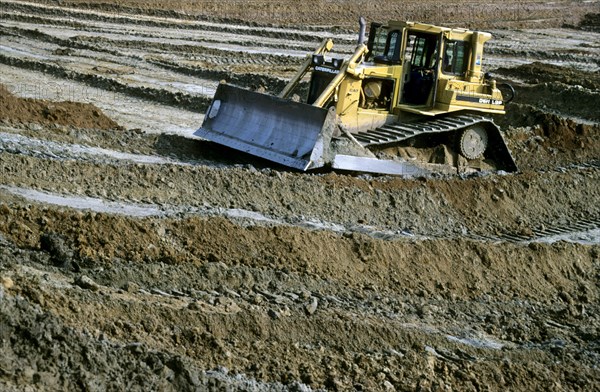 Navvy work done by bulldozer on construction site