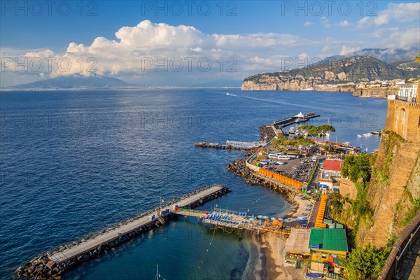 Bathing terraces by the sea with town and Vesuvius