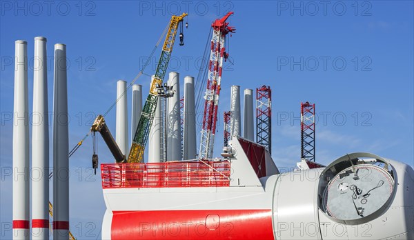 Wind turbine nacelle with rotor hubs and tower sections for offshore SeaMade wind farm at REBO heavy load terminal in Ostend port