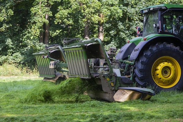 Grass mowing in a small field near Waldheim with a John Deere tractor