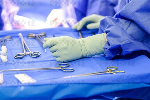 Operating table with surgical cutlery during an operation in a hospital