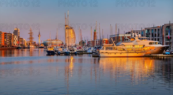Marina in the New Harbour with yachts and pleasure boats in front of the Atlantic Sail City Hotel in the evening sun