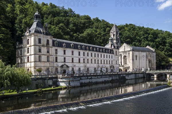 The Benedictine abbey abbaye Saint-Pierre de Brantome and its bell tower along the river Dronne