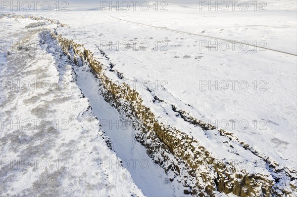 Aerial view over the Almannagja Canyon in the snow in winter