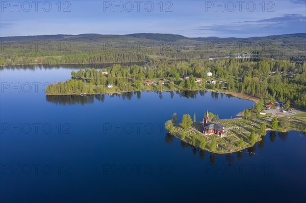 Aerial view over the red wooden Raemmens kyrka