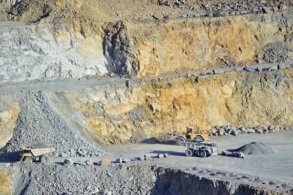 Trucks at work in porphyry quarry