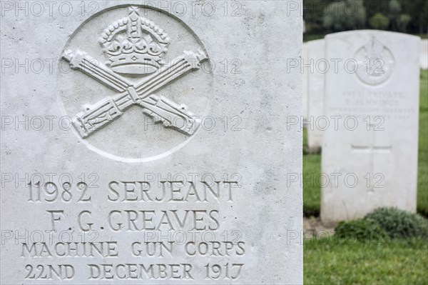 Machine Gun Corps regimental badge on headstone at Cemetery of the Commonwealth War Graves Commission for First World War One British soldiers