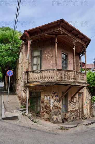 House in need of renovation with balcony