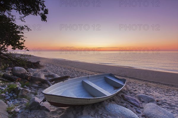 Rowboat on desolate sandy beach of Knaebaeckshusen