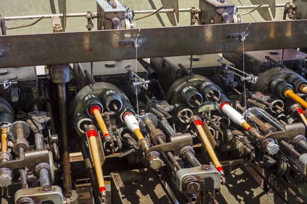 Bobbins with yarns on spool machine in cotton mill