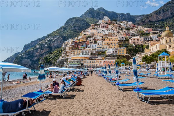 Beach with beach chairs and view of the village