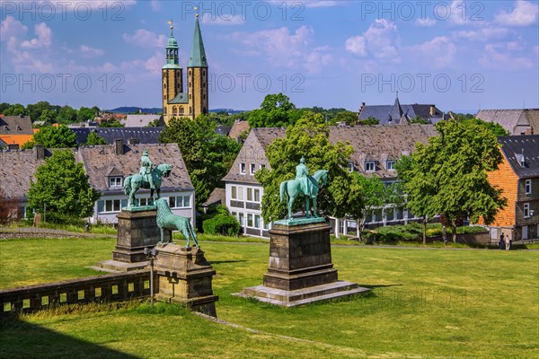 Equestrian statues of Emperor Wilhelm I and Emperor Barbarossa in front of the Imperial Palace with the towers of the Market Church