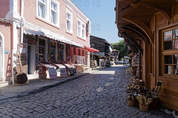 Half-timbered houses with wooden tops and roof overhangs typical of the locality on the cobbled street in the old town. Sozopol