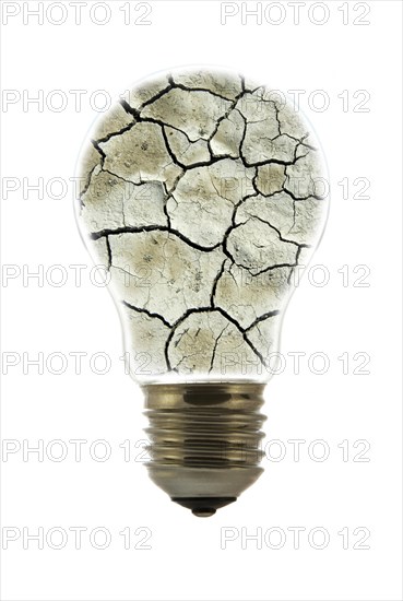 Cracked earth by drought inside incandescent lamp
