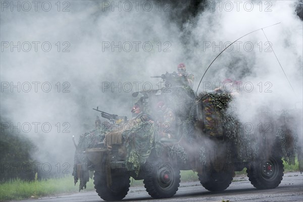 Smoke curtain and Belgian paracommandos of the Para-Commando Regiment under attack in camouflaged LRPV armoured vehicle